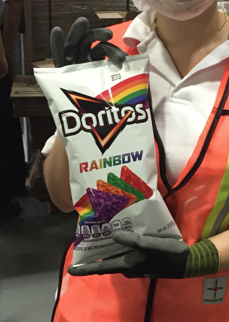 Production floor worker holding a Doritos Rainbow bag